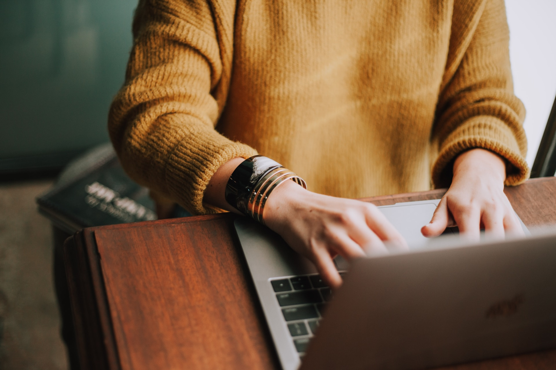 A person looking at a laptop with a diagram of the chargeback process