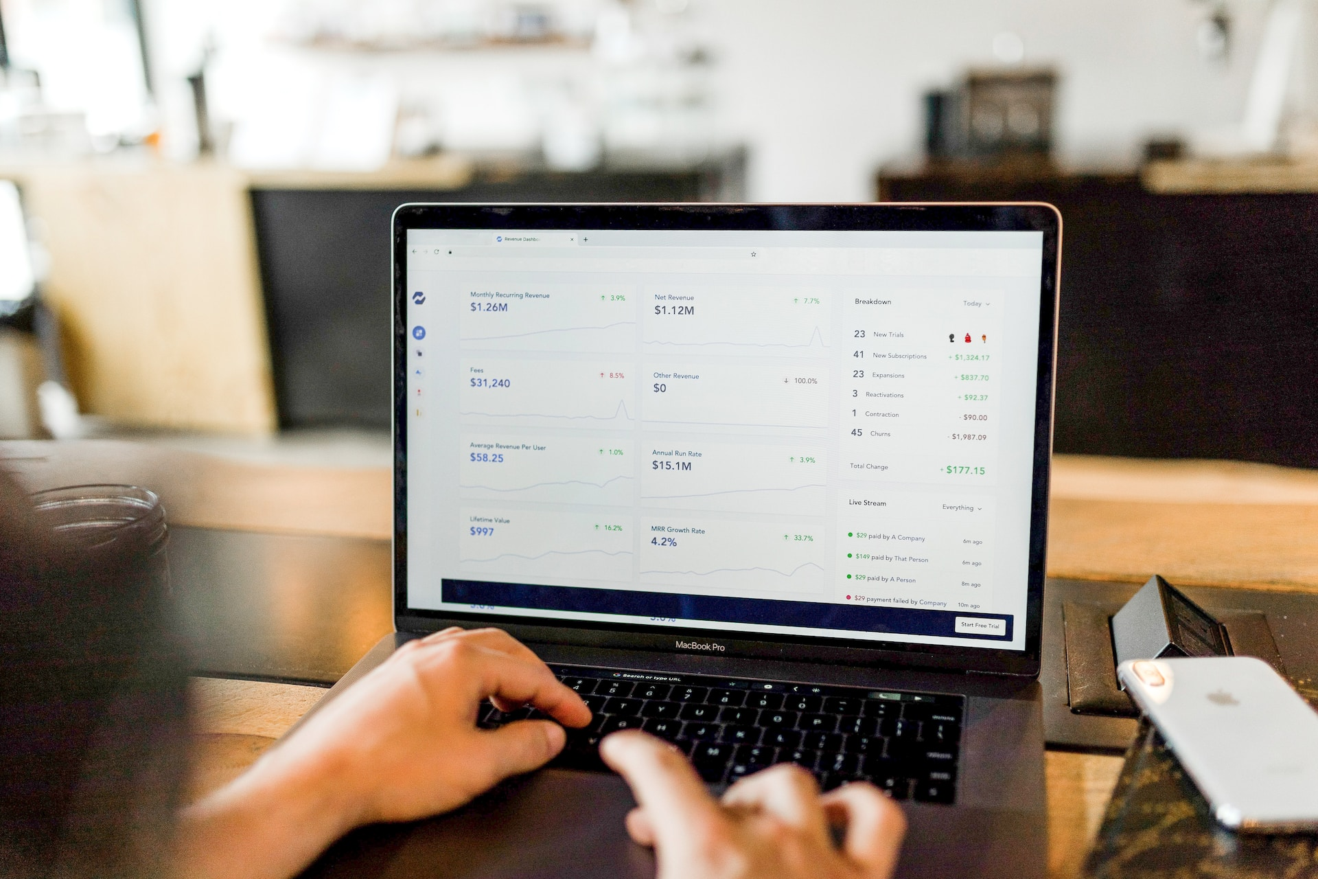 A person using a laptop to access their PayPal account and view their instant transfer limits